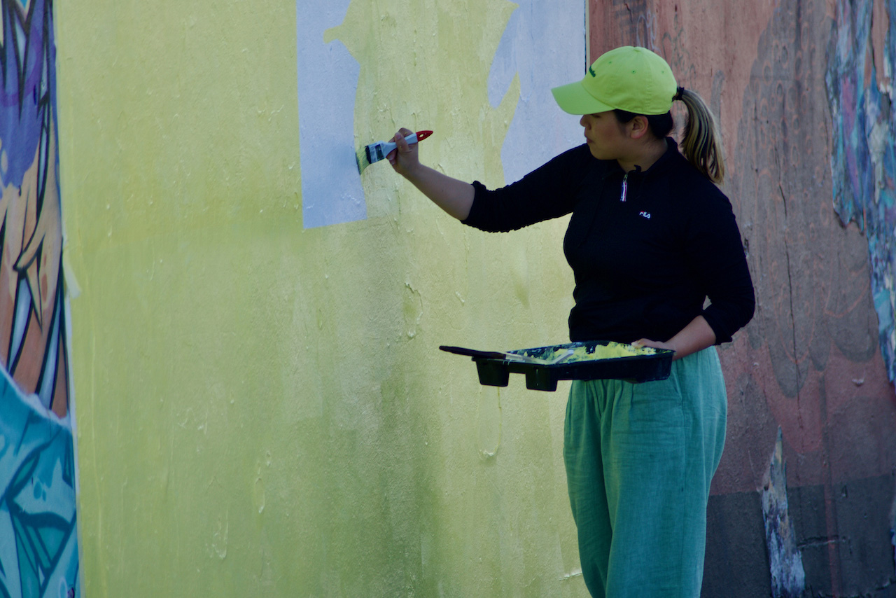 Yasuko painting mural at Bondi Beach, Sydney, 2023
